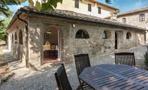 a table and chairs in front of a building at Fattoria Agriturismo Nerbona in Casole dʼElsa