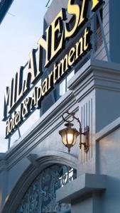 a sign on the side of a building with a light at Milanesa Hotel and Apartment in Vung Tau