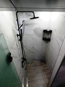 a bathroom with a walk in shower with a marble wall at Villa Riviera in Stavros