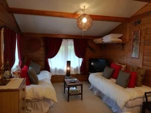 a living room with two beds and a table at Snowfall Meteor 飛雪流星 in Kaminoyama