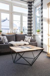 a living room with a couch and a coffee table at Pokoje Janosik in Zakopane