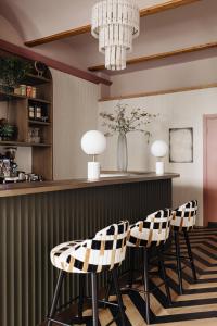 a bar with two chairs and a counter at Parklane Hotel in Amsterdam