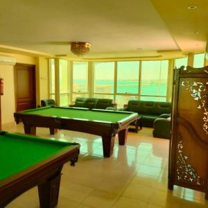 a billiard room with a pool table and chairs at Salvatore Rooms with Breakfast in Suez