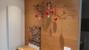 a wall with red christmas ornaments on it at i Design Apartment in Ljubljana