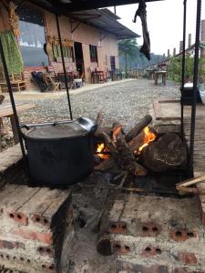 a pot sitting on top of a fire at Bao Lac Homestay Hostel & Coffee in Bảo Lạc