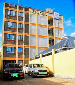 ein Gebäude mit davor geparkt in der Unterkunft Royalty Homes in Nairobi