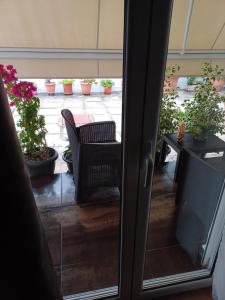 an open door to a patio with potted plants at Rafina's blue heart! in Rafina