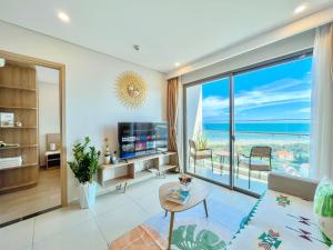 a living room with a view of the ocean at HomeAway - The Sóng Vũng Tàu LUX Condotel in Vung Tau