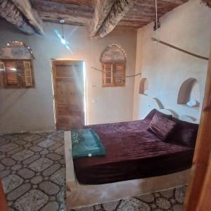 a bedroom with a bed in a room with windows at Santarya hotel in Siwa