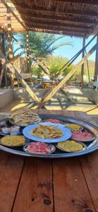 a tray filled with plates of food on a table at Santarya hotel in Siwa