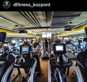 a gym with a bunch of cardio machines at Oxygen Home in Nyíregyháza