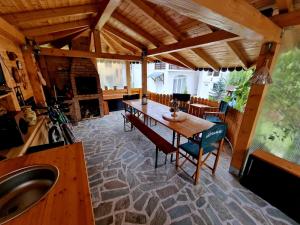 a dining room with a wooden table and chairs at Casa La Buni in Buşteni