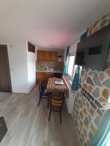 a small kitchen with a table in a tiny house at Apartment Matej in Kruševo