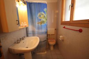 a bathroom with a sink and a toilet and a shower at Agenzia Vear - Lido degli Scacchi in Lido di Pomposa