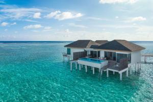 a house in the middle of the water at Le Méridien Maldives Resort & Spa in Lhaviyani Atoll