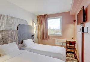 Postel nebo postele na pokoji v ubytování B&B HOTEL Montluçon Saint-Victor