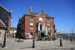 a large red brick building with a flag on it at Little Gem in Poole