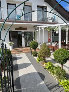 a house with a porch with a bench in front of it at WiLLA ZAKĄTEK in Grzybowo