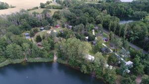 an aerial view of a lake with houses and trees at Feriendorf am Flämingbad Bungalow in Coswig