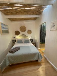 a bedroom with a large bed in a room at Dreamtime Studio in Kommetjie