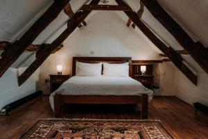 a bedroom with a large bed in a attic at Treleddyn Farmhouse in St. Davids