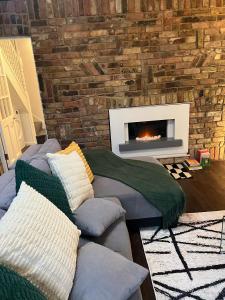 a living room with a couch and a fireplace at Stylish Apartment in CENTRAL LONDON in London