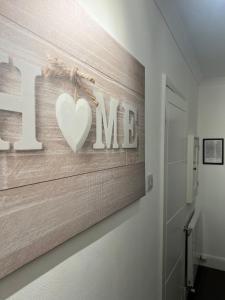 a wall with a sign that says i love me at Stylish Apartment in CENTRAL LONDON in London