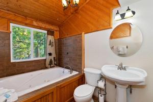 a bathroom with a tub and a toilet and a sink at 050 - The Great Escape - Meredith Lodging in Big Bear City +67 photos