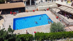 an overhead view of a swimming pool with people in it at Apartamentos Los Olivos in Alcalá del Júcar