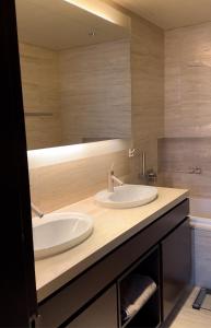 a bathroom with two sinks and a large mirror at Burj Khalifa in Dubai