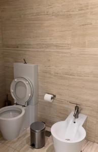 a bathroom with a toilet and a sink at Burj Khalifa in Dubai