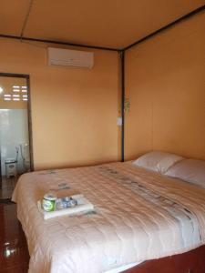 a bedroom with a bed with a tray on it at Don Det Sokxay and Mamapieng Budget Guesthouse in Don Det