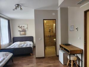 a bedroom with a bed and a walk in shower at Főnix Badacsony in Badacsonytomaj +68 photos