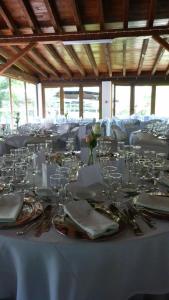 a long white table with glasses and napkins on it at Quinta Entre Rios in Mirandela