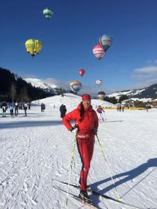 a woman on skis in the snow with hot air balloons at Haus Anna in Fischen
