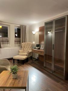 a living room with a chair and a desk at Haus Boutique in Bad Salzuflen