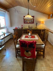 a dining room with a table with a red napkin at Waldhaus Max in Bad Wildbad