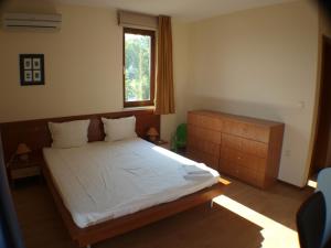 a bedroom with a large bed and a window at Nessebar View Apartament in Nesebar