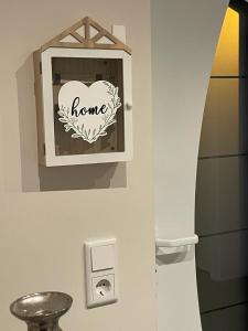 a bathroom with a home sign on a wall at Haus Boutique in Bad Salzuflen