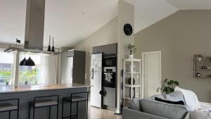 a kitchen and living room with a couch and a counter at New luxurious Villa in Helsingborg close to the City in Helsingborg