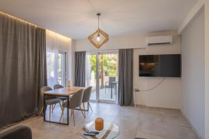 a living room with a table and a dining room at Tertsa Suites in Térsa