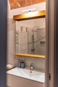 a bathroom with a sink and a mirror at Domus Antiche Mura in Asti