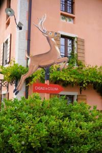 a statue of a deer on the side of a building at Casale in Collina in Capriva del Friuli