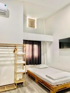 a bedroom with a bunk bed and a ladder at Homestay KV in Can Tho