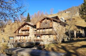 a large log house in the mountains at L'Etoile Du Berger in Lillianes