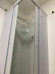a shower with a glass door in a bathroom at Pousada Terra Bela in Juazeiro do Norte
