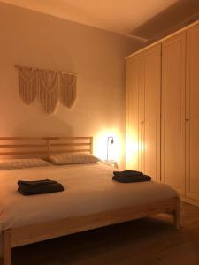 a bedroom with a large white bed with a dresser at Maison Bohémienne in Livorno