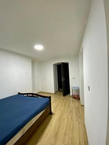 a bedroom with a bed and a wooden floor at дом в старом тбилиси in Tbilisi City