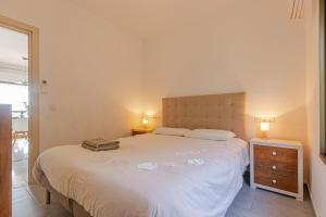 a bedroom with a bed with a suitcase on it at Nice Villa Anna Private Pool Garden Seaview in Benalmádena +30 photos