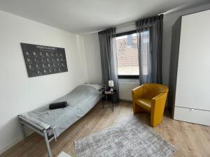 a bedroom with a bed and a chair and a window at MyTimeHouse in Ober-Ramstadt +13 photos